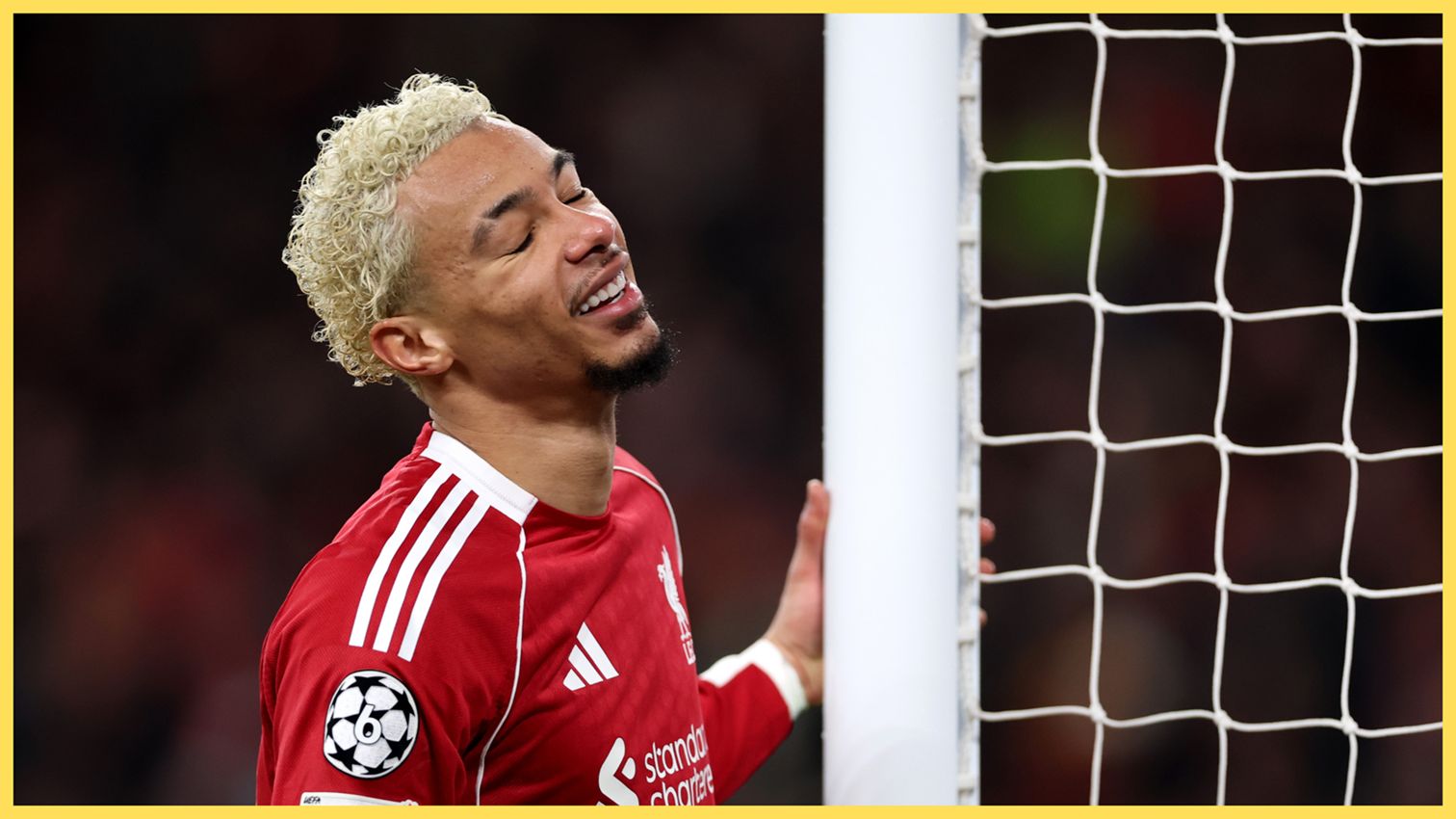 Hugo Ekitike holds the goalpost and closes his eyes during Liverpool game.