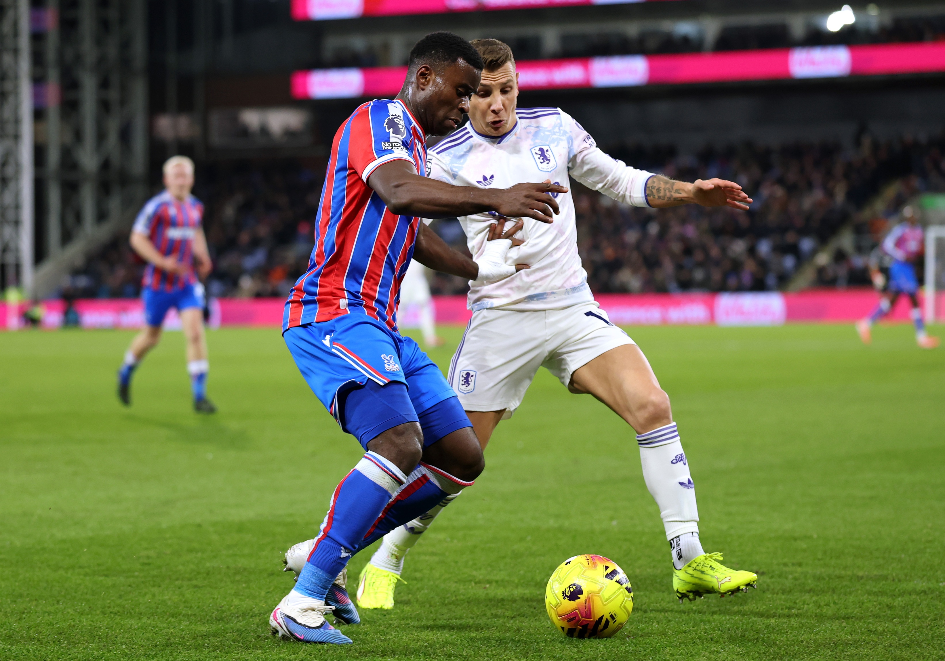 Marc Guehi competes with Lucas Digne for possession.