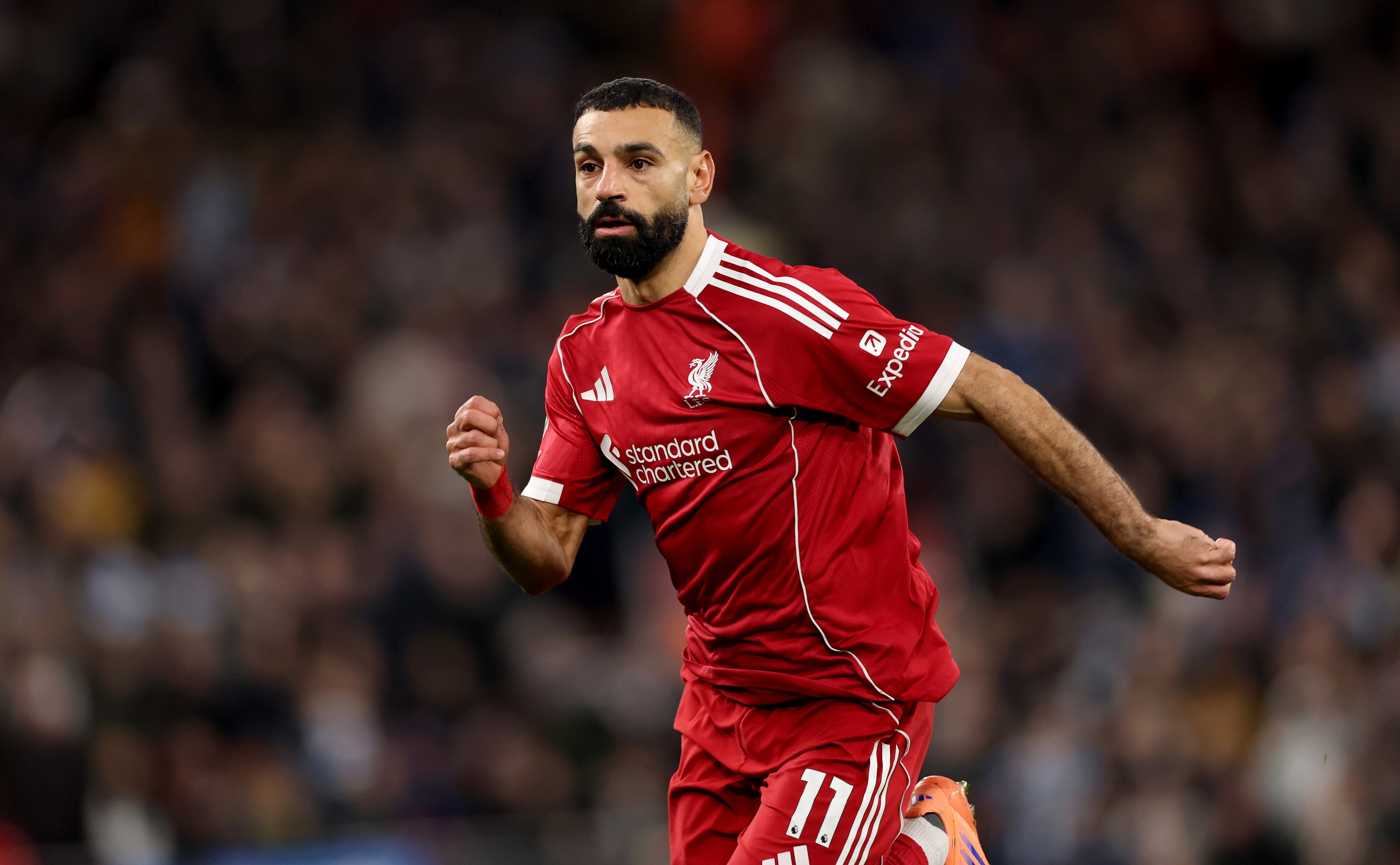 Mo Salah runs on the pitch for Liverpool.