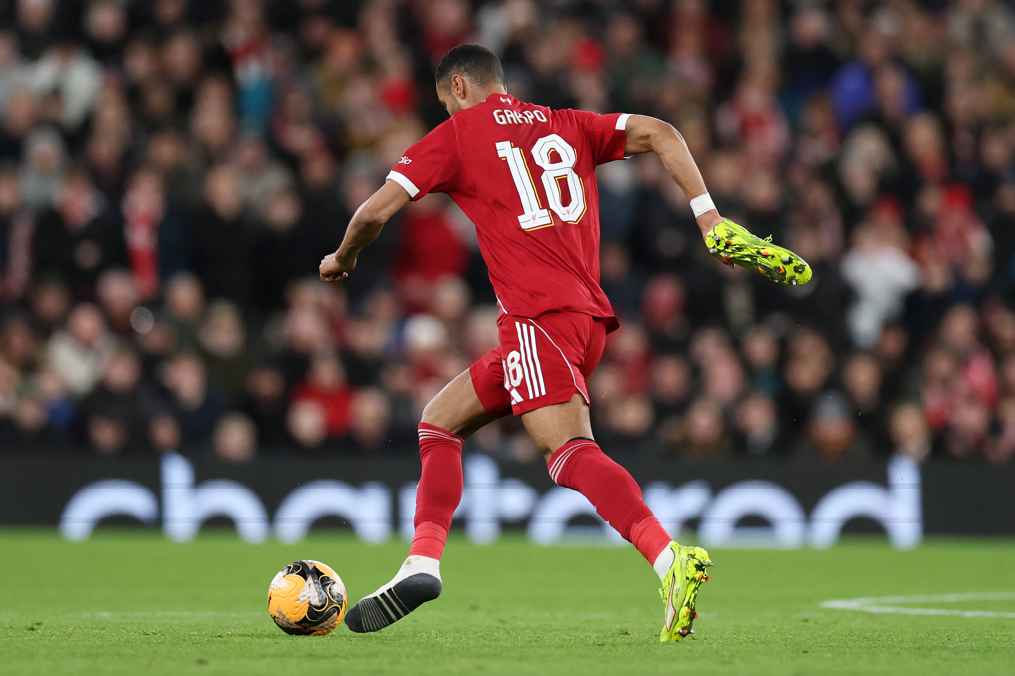 Cody Gakpo runs with his boot in his hand during Liverpool's win over Barnsley