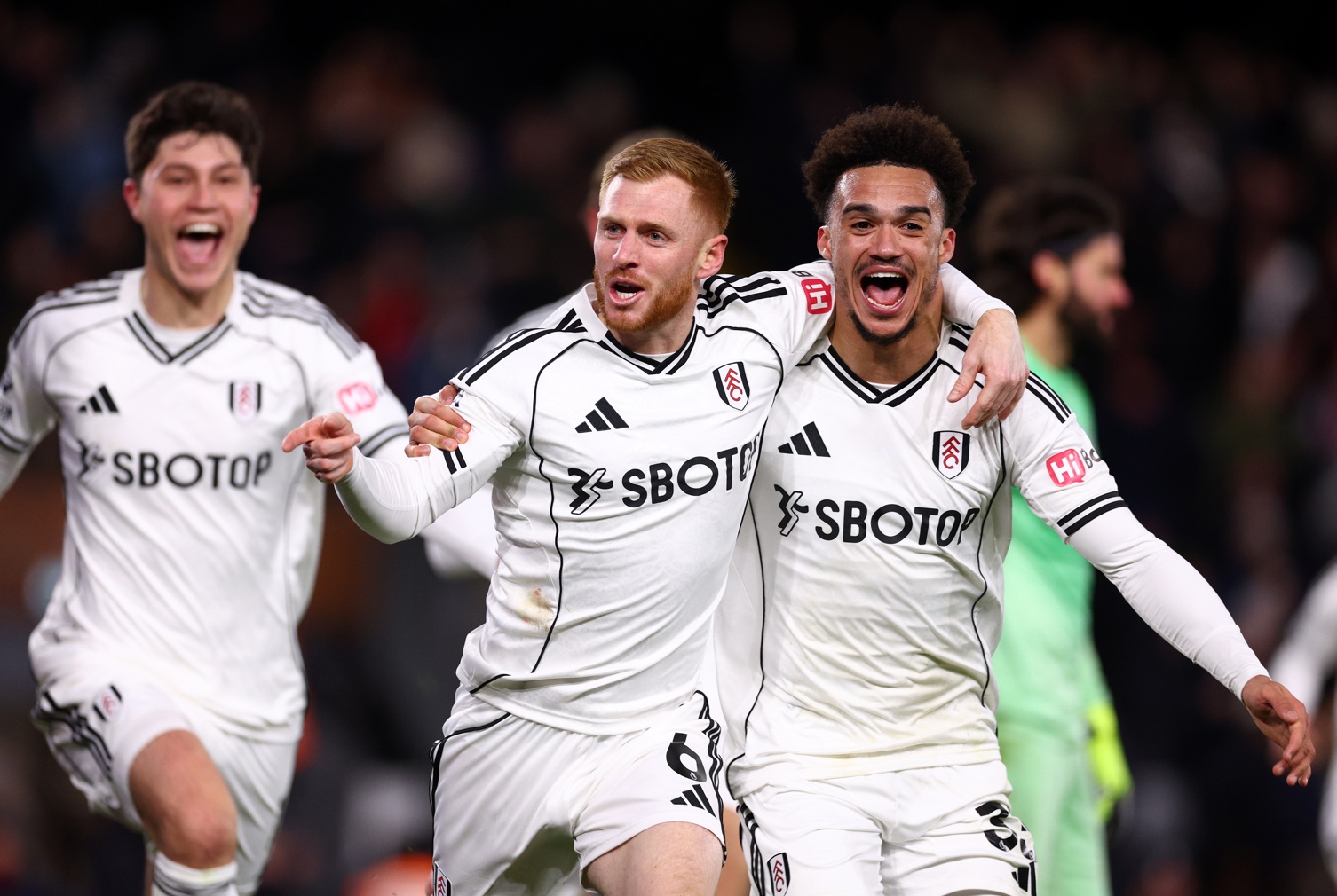 Harrison Reed celebrates with Antonee Robinson after equalising for Fulham against Liverpool