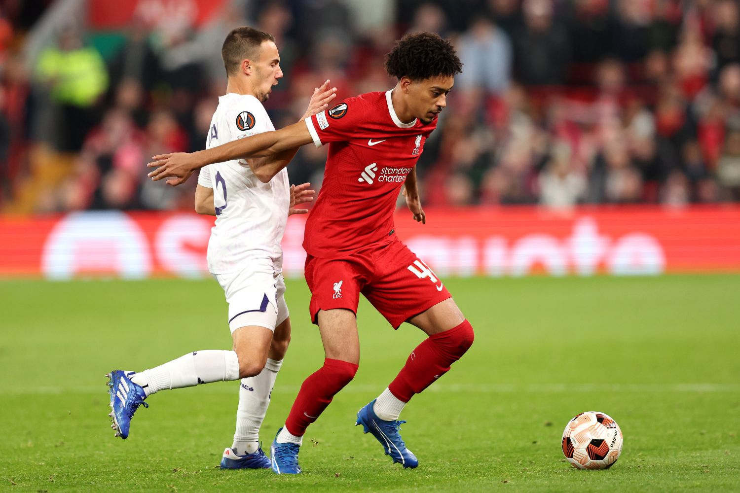 Calum Scanlon of Liverpool on the ball whilst under pressure from Denis Genreau of Toulouse