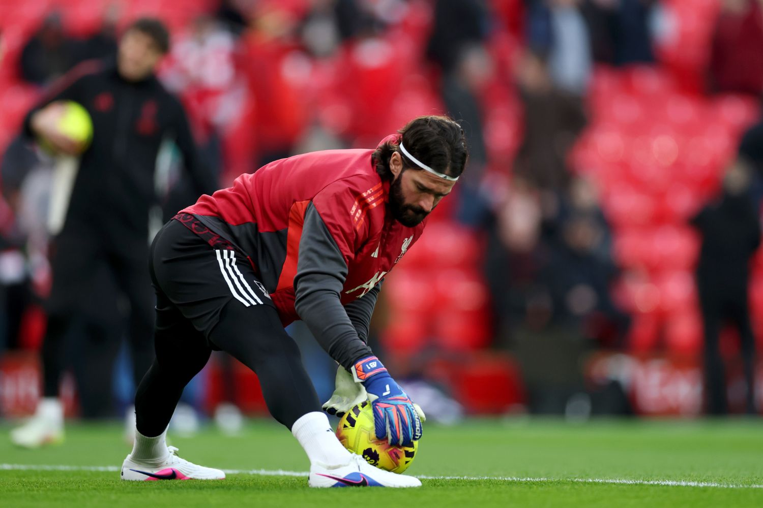 Alisson Becker of Liverpool warms up
