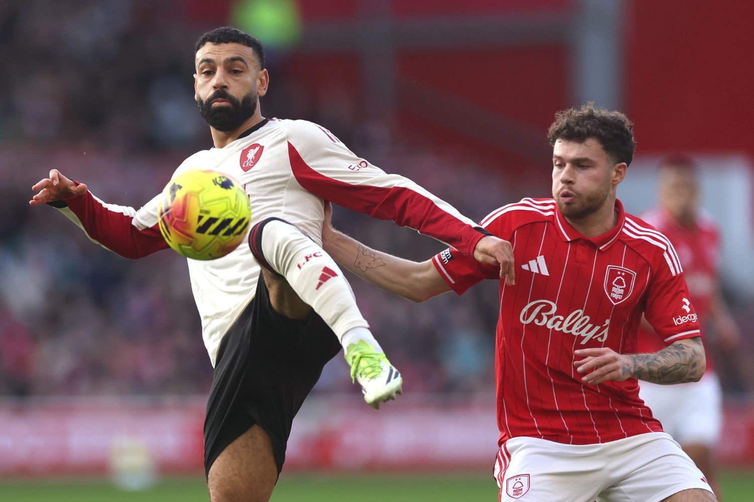 Mo Salah and Nico Williams battle for the ball