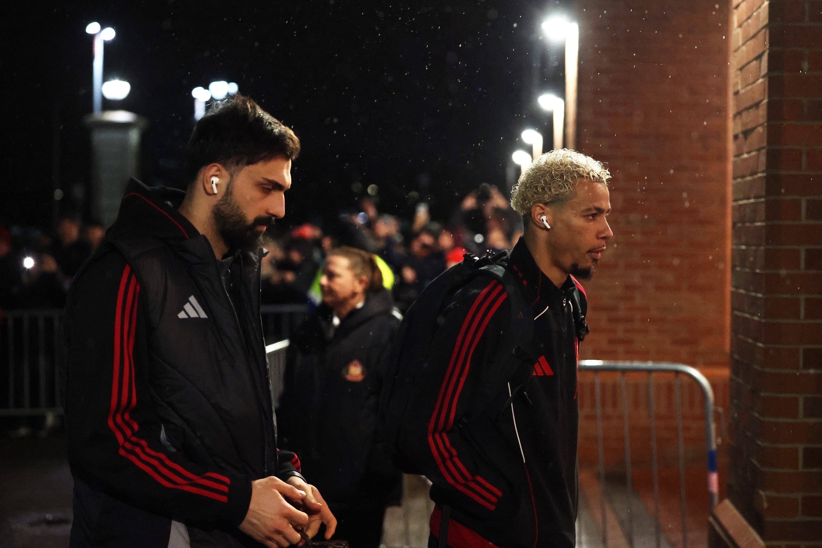 Hugo Ekitike enters the Stadium of light alongside Giorgi Mamardashvili.