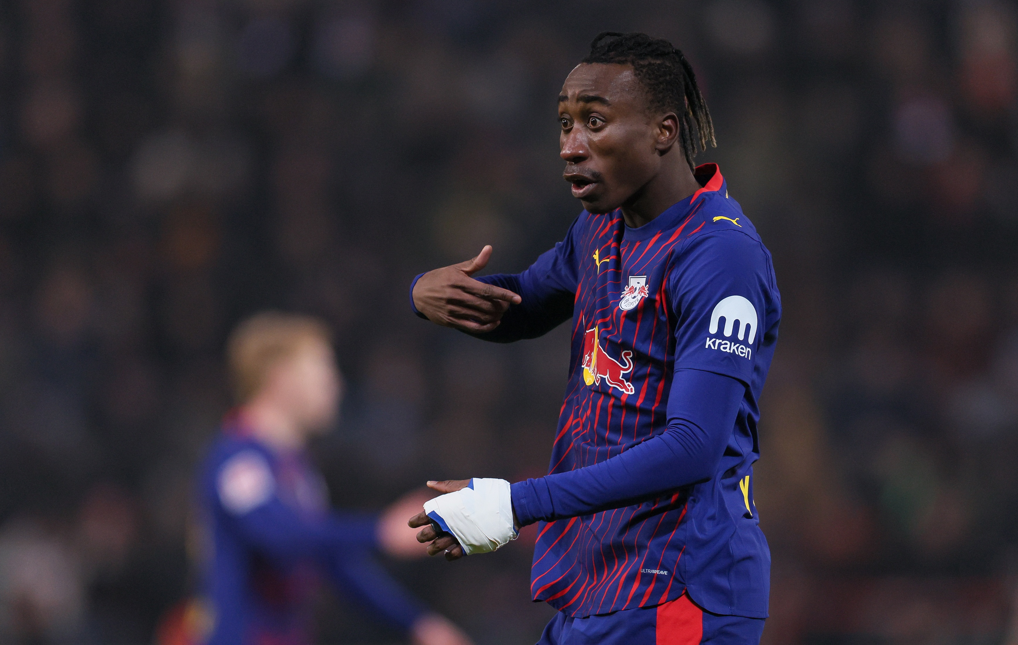 Yan Diomande gestures at himself with one hand.