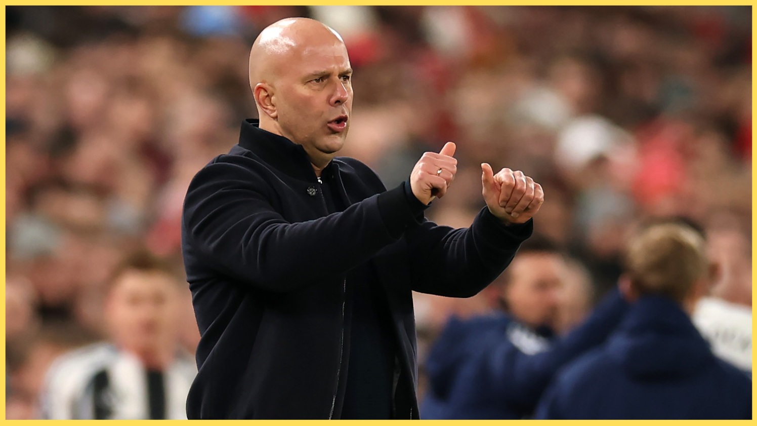 Arne Slot gives a thumbs-up from the Anfield dugout