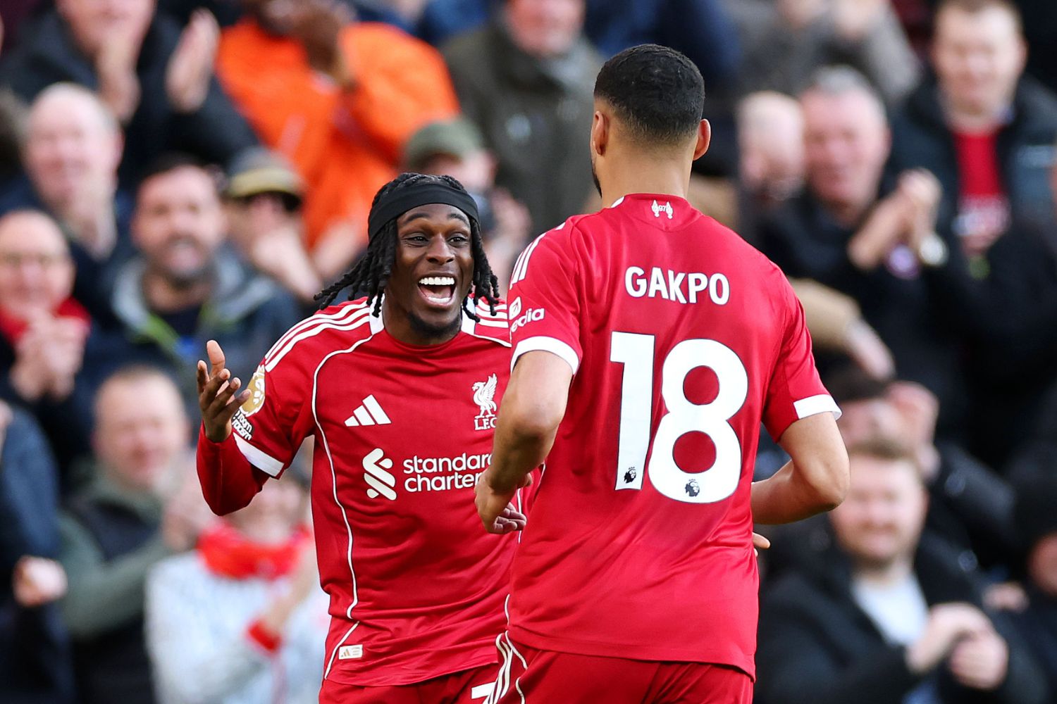 Jeremie Frimpong of Liverpool celebrates with teammate Cody Gakpo, after Axel Disasi of West Ham United (not pictured) concedes an own goal