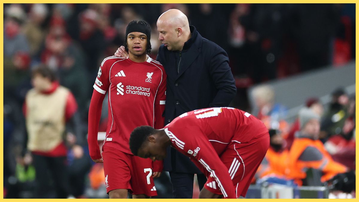 Arne Slot, Manager of Liverpool, interacts with Rio Ngumoha