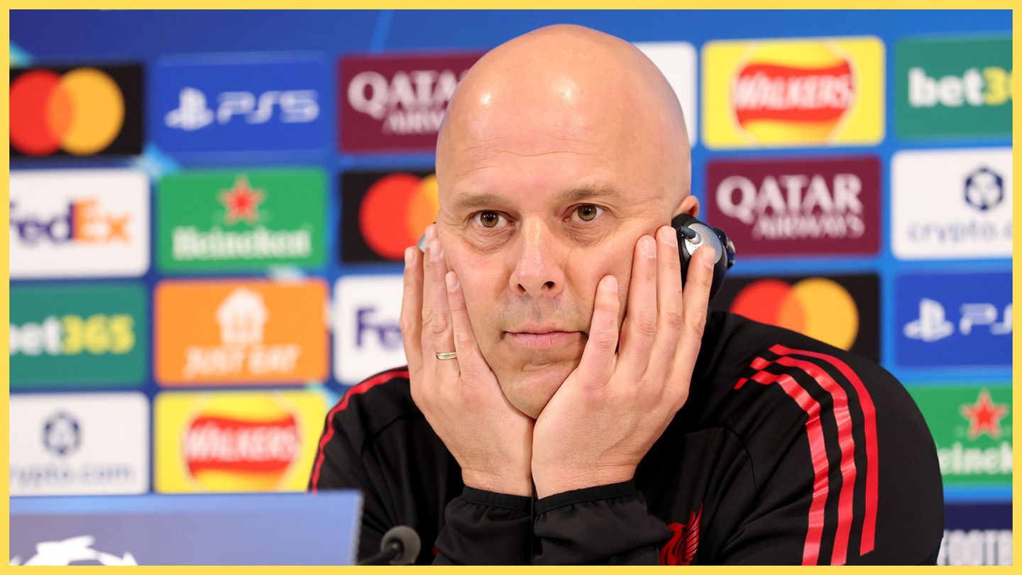 Arne Slot holds his head in both hands during Liverpool presser.