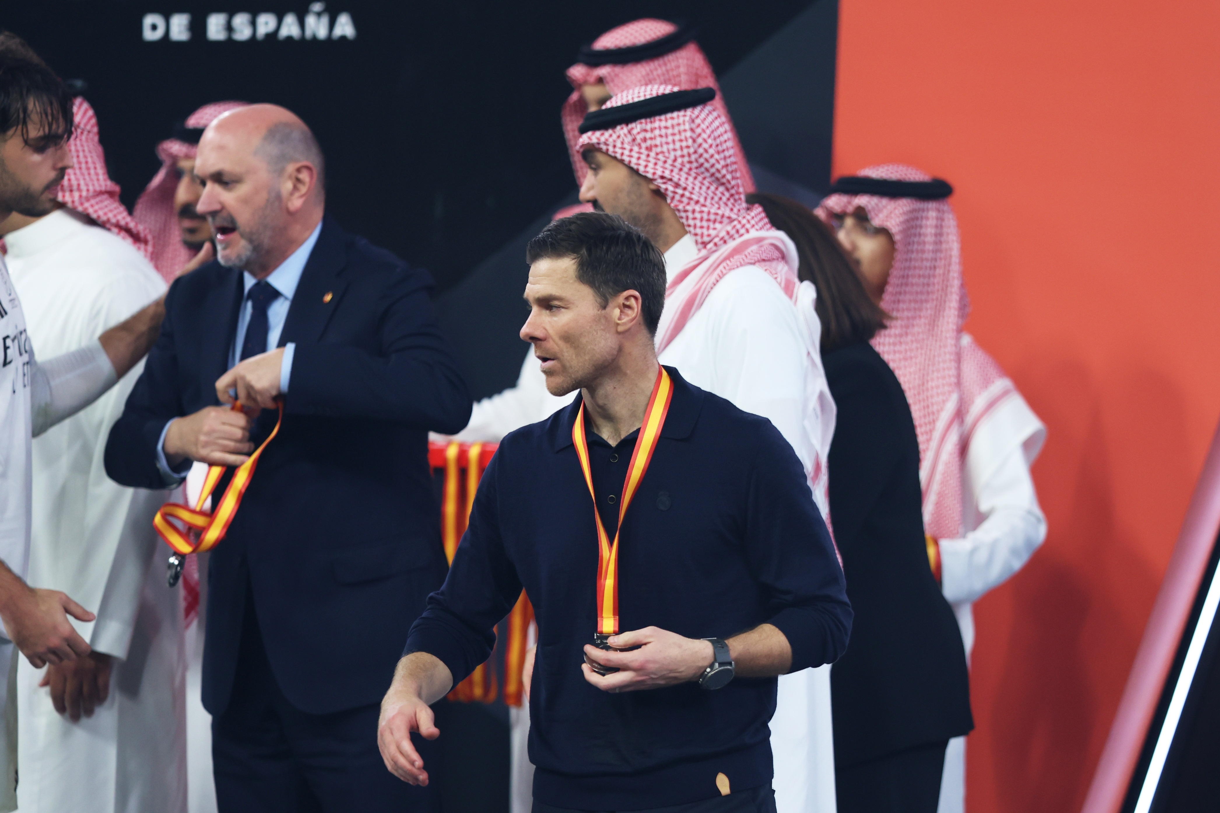Xabi Alonso walks off with a runners-up medal.