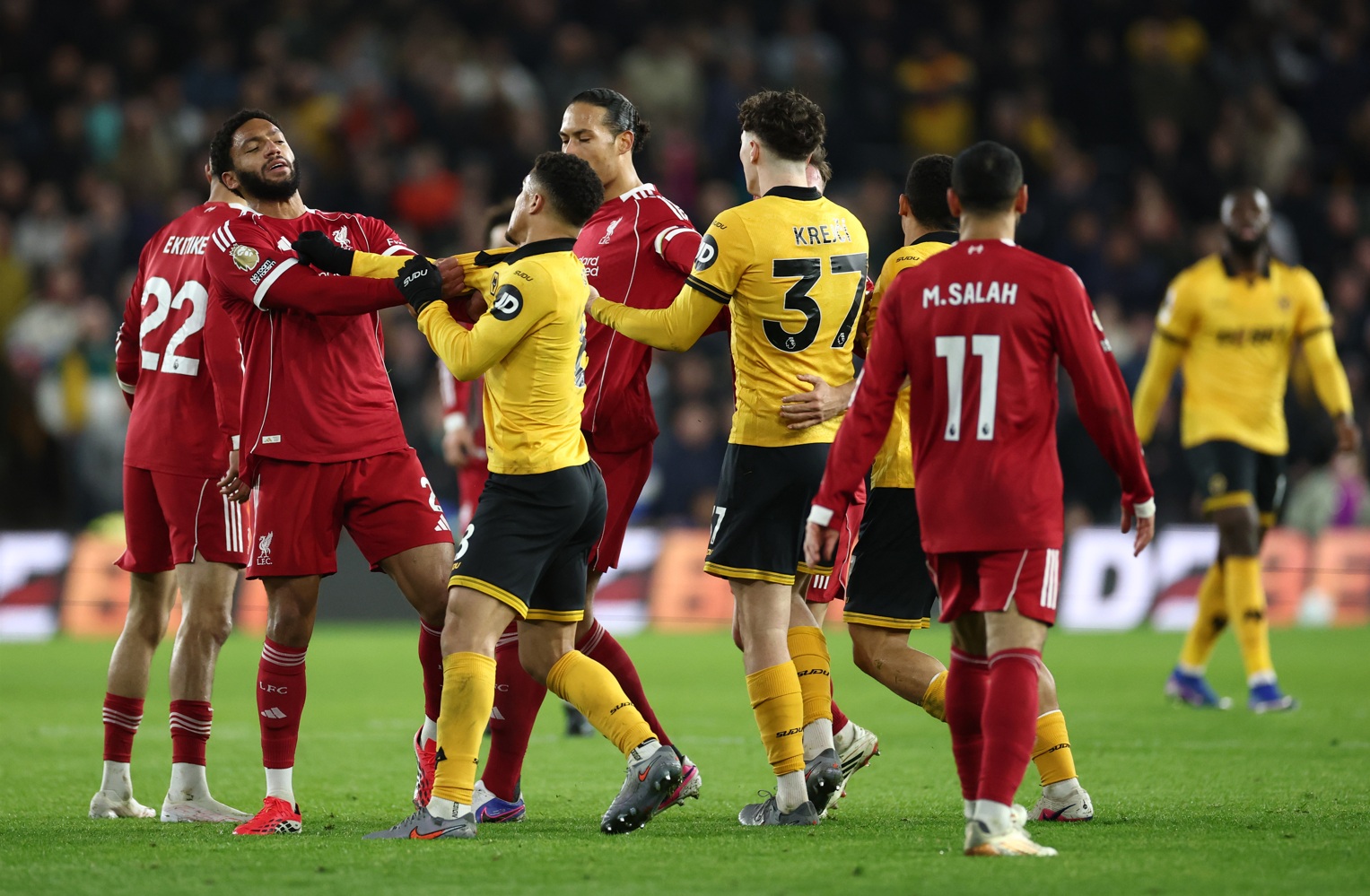 Joe Gomez and Joao Gomez grapple with one another in Liverpool's defeat to Wolves at Molineux