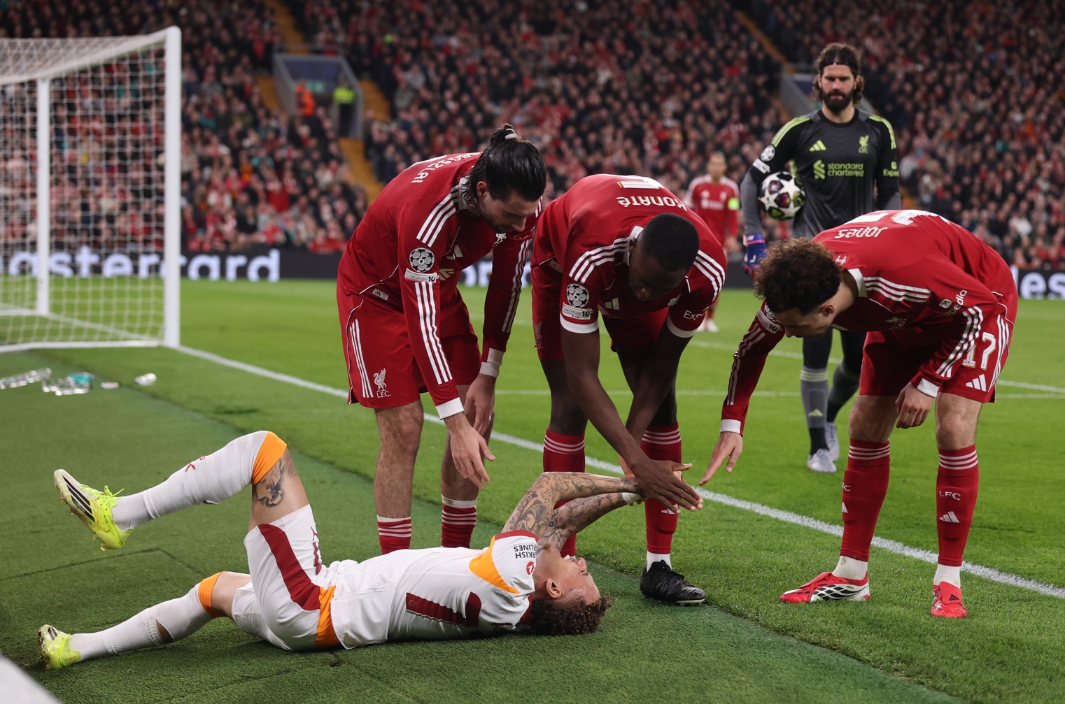 Ibrahima Konate comes over to check on the welfare of Noa Lang after colliding with a pitchside hoarding at Anfield