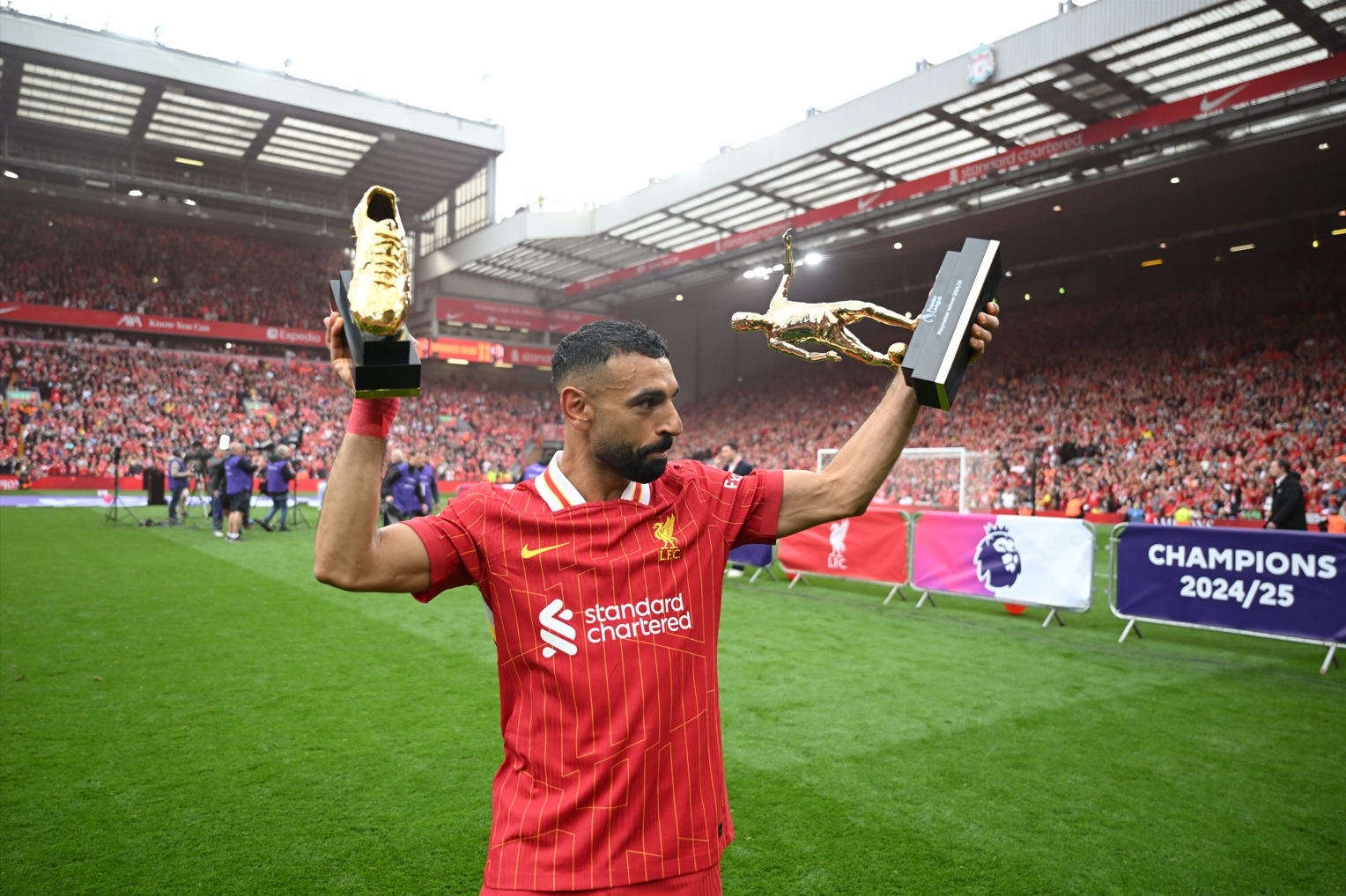 Mo Salah poses with his Premier League Golden Boot and Playmaker awards from the 2024/25 season