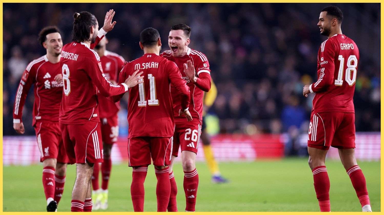 Liverpool players celebrate after scoring against Wolves
