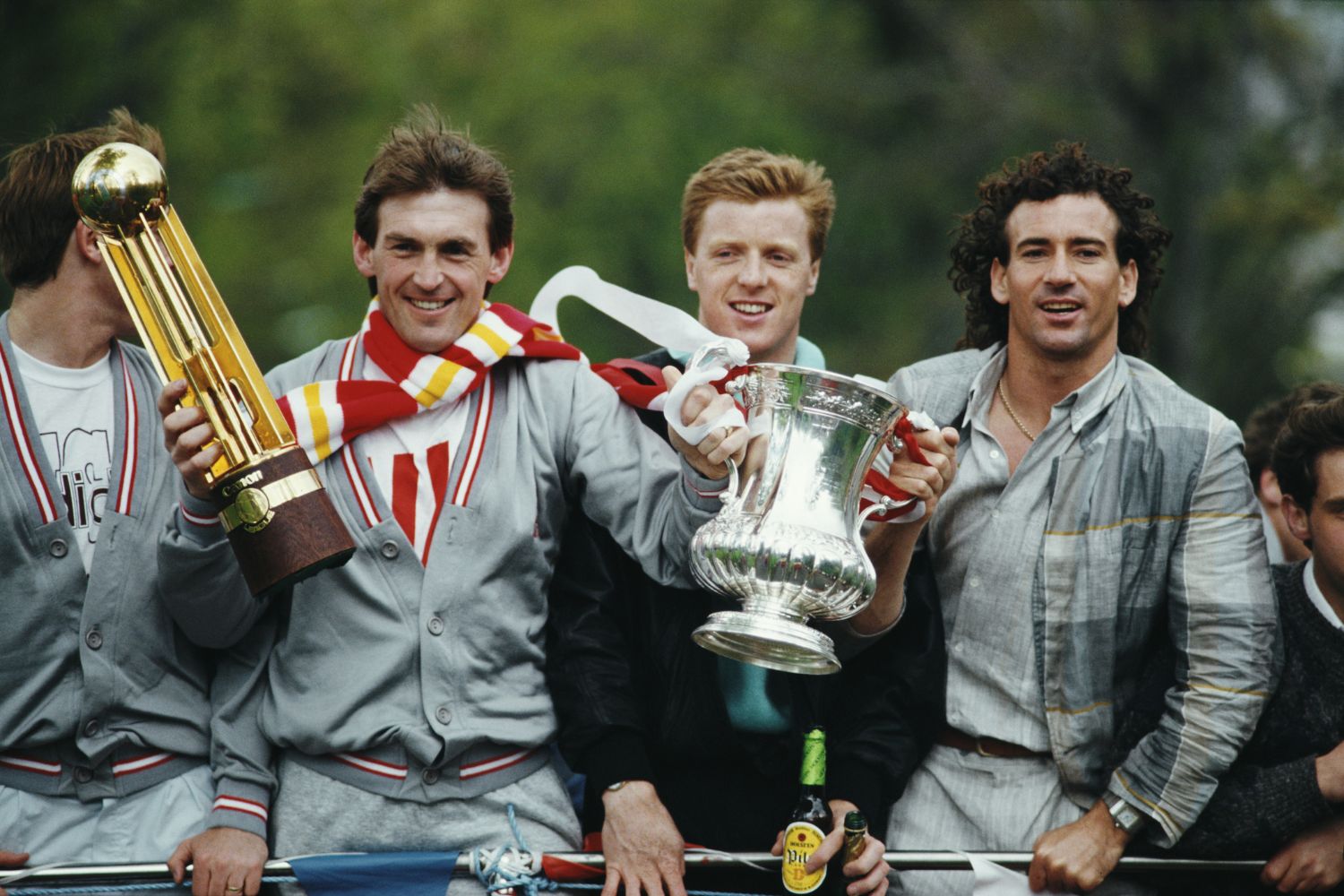 Liverpool player Craig Johnston (right) wiith player/manager Kenny Dalglish (l) and Steve Nicol (c) celebrate with the trophies during the teams homecoming Bus Parade after the FA Cup final against Everton at Wembley Stadium in London, Liverpool won the match 3-1 to gain a League Championmsip and Cup double