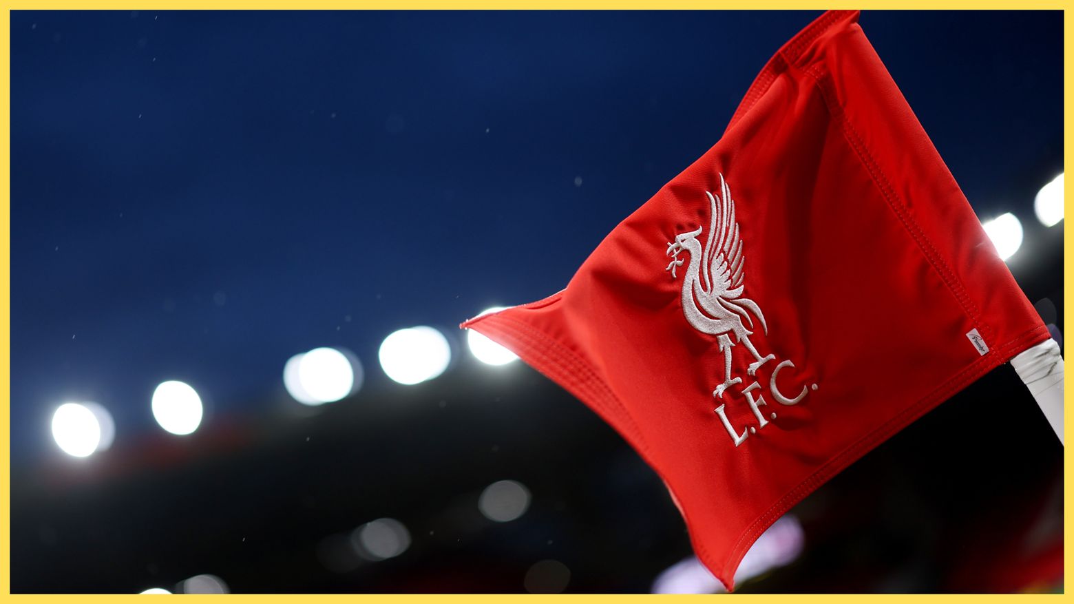 Liverpool corner flag flaps in the wind at Anfield.
