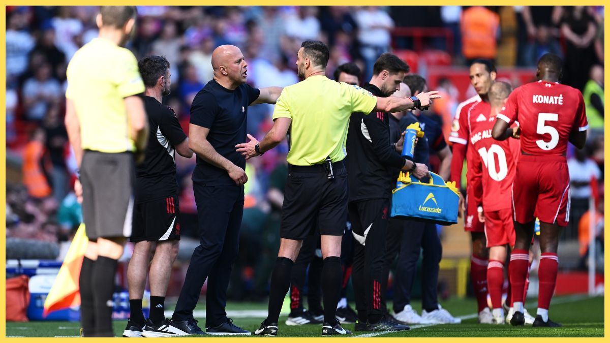 Arne Slot, Manager of Liverpool, speaks with Referee, Andy Madley during the Premier League match between Liverpool and Crystal Palace at Anfield