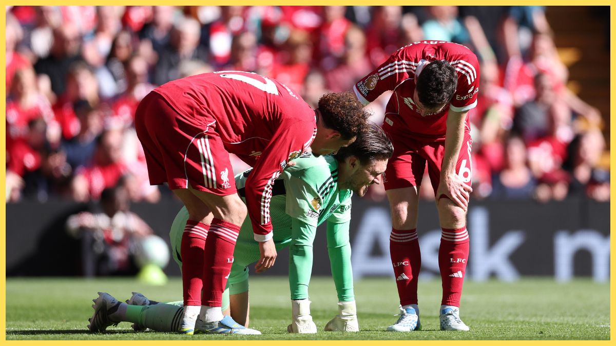 Freddie Woodman of Liverpool reacts with teammates Curtis Jones and Andrew Robertson after picking up an injury during the Premier League match between Liverpool and Crystal Palace at Anfield