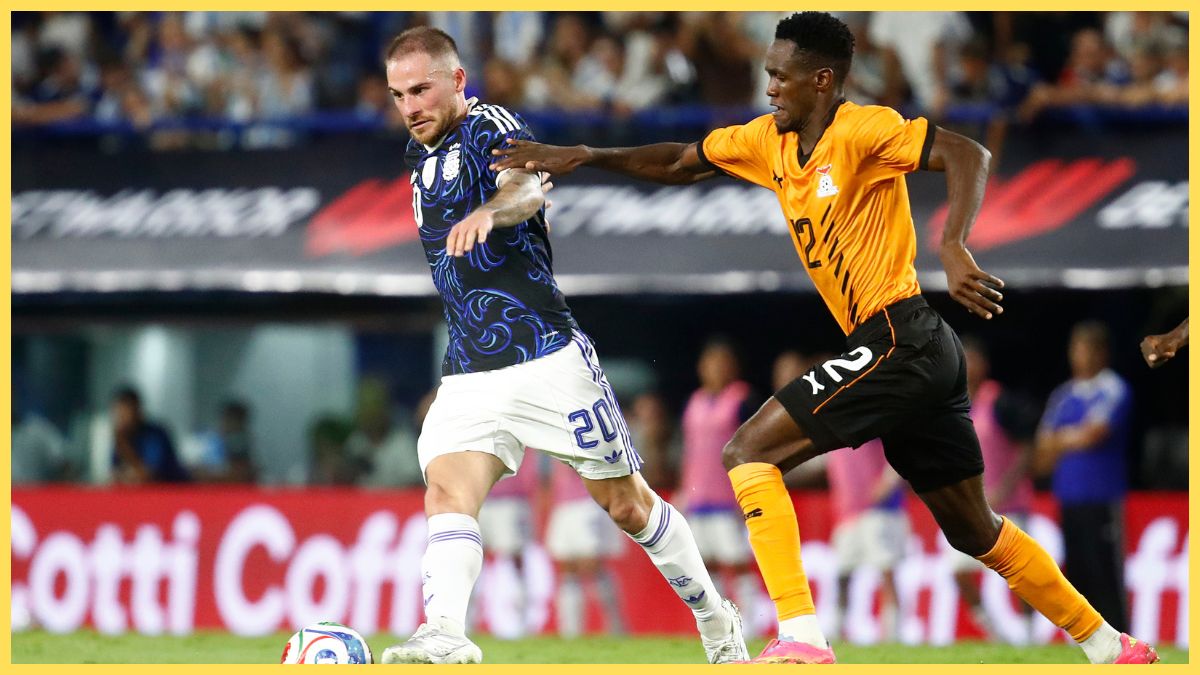 Alexis Mac Allister of Argentina is challenged by Wilson Chisala of Zambia during the international friendly match between Argentina and Zambia at Estadio Alberto J. Armando