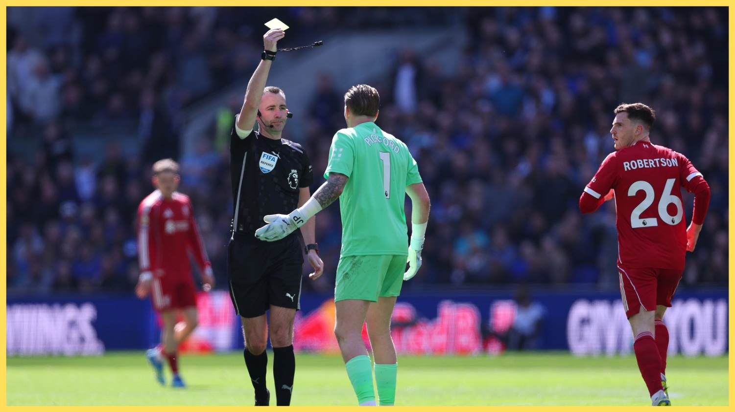 Chris Kavanagh shows Jordan Pickford a yellow card in the Merseyside derby