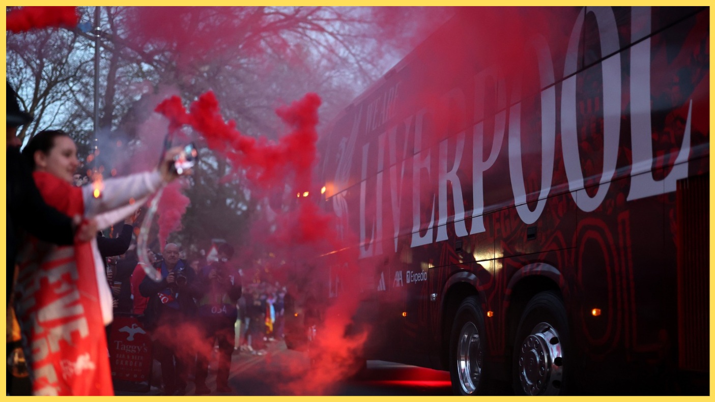 Liverpool fans greet the team bus before a game at Anfield
