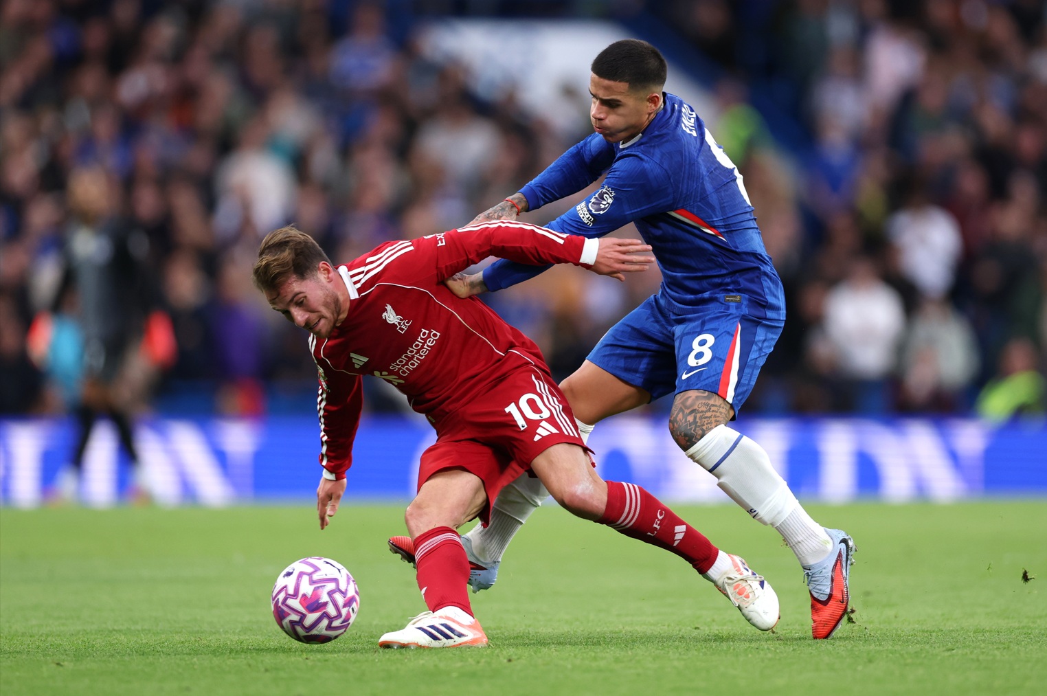 Alexis Mac Allister is challenged by Enzo Fernandez