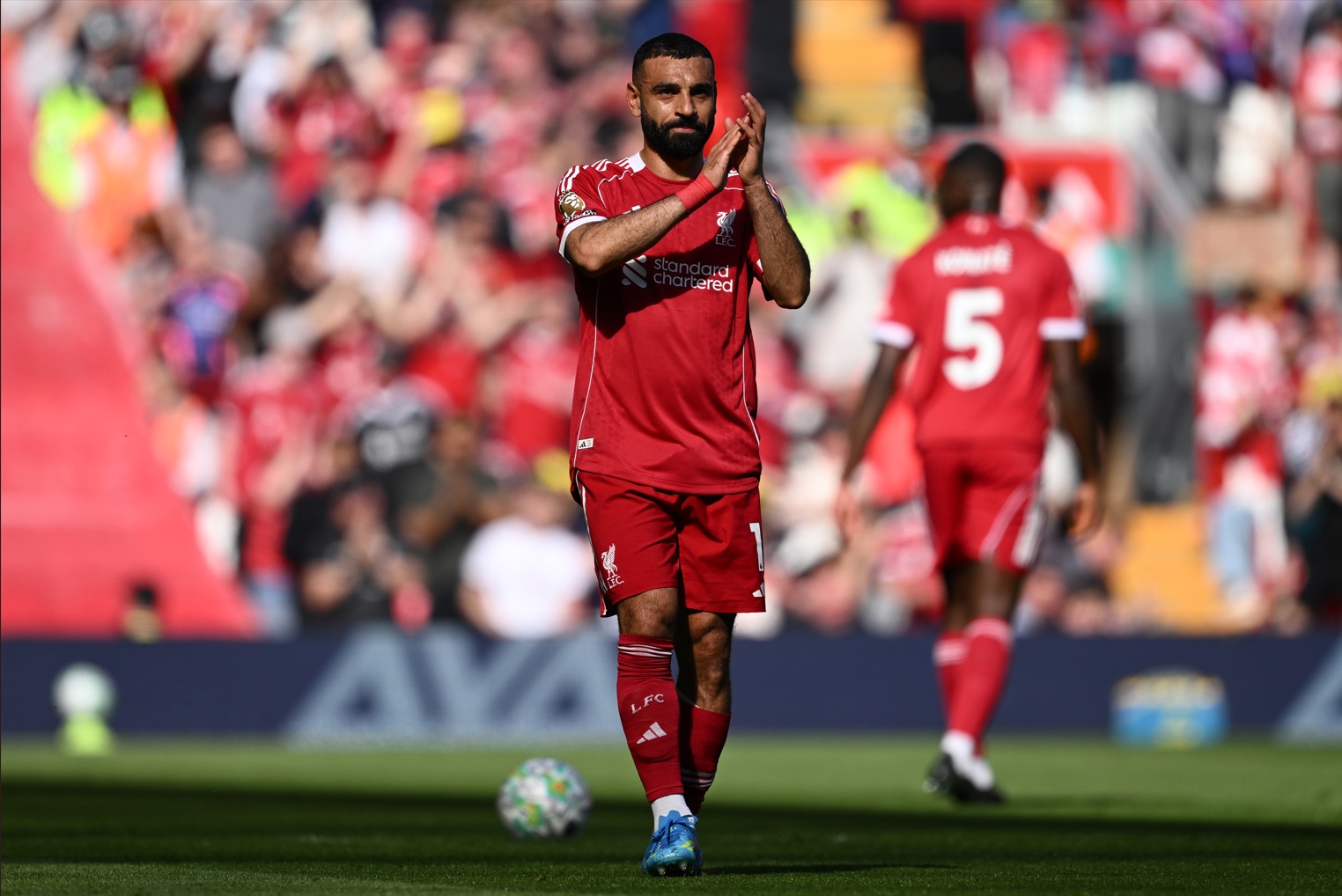 Mo Salah applauds the Liverpool fans as he leaves the pitch after going off injured against Crystal Palace