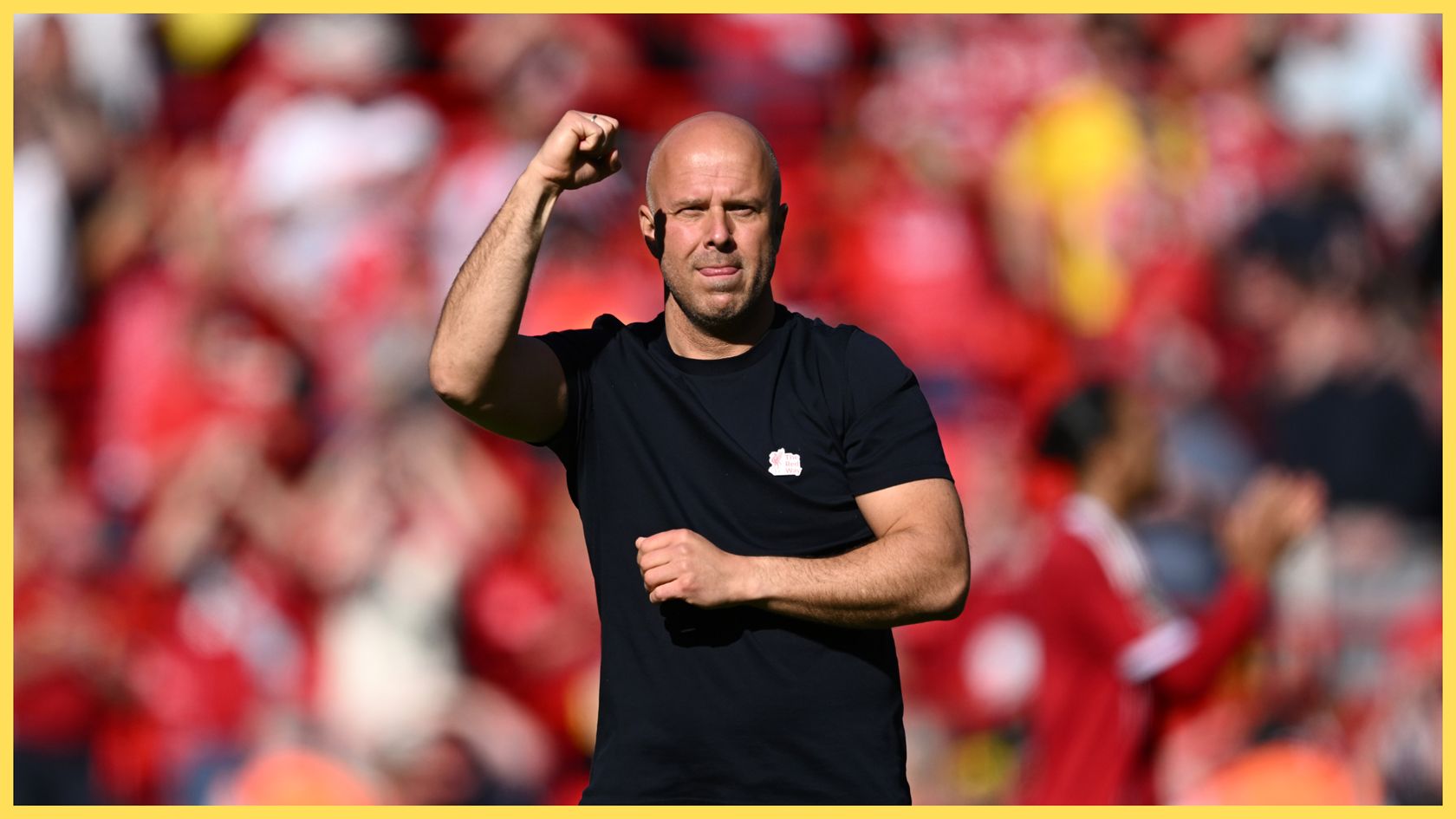 Liverpool head coach Arne Slot raises his fist in celebration.
