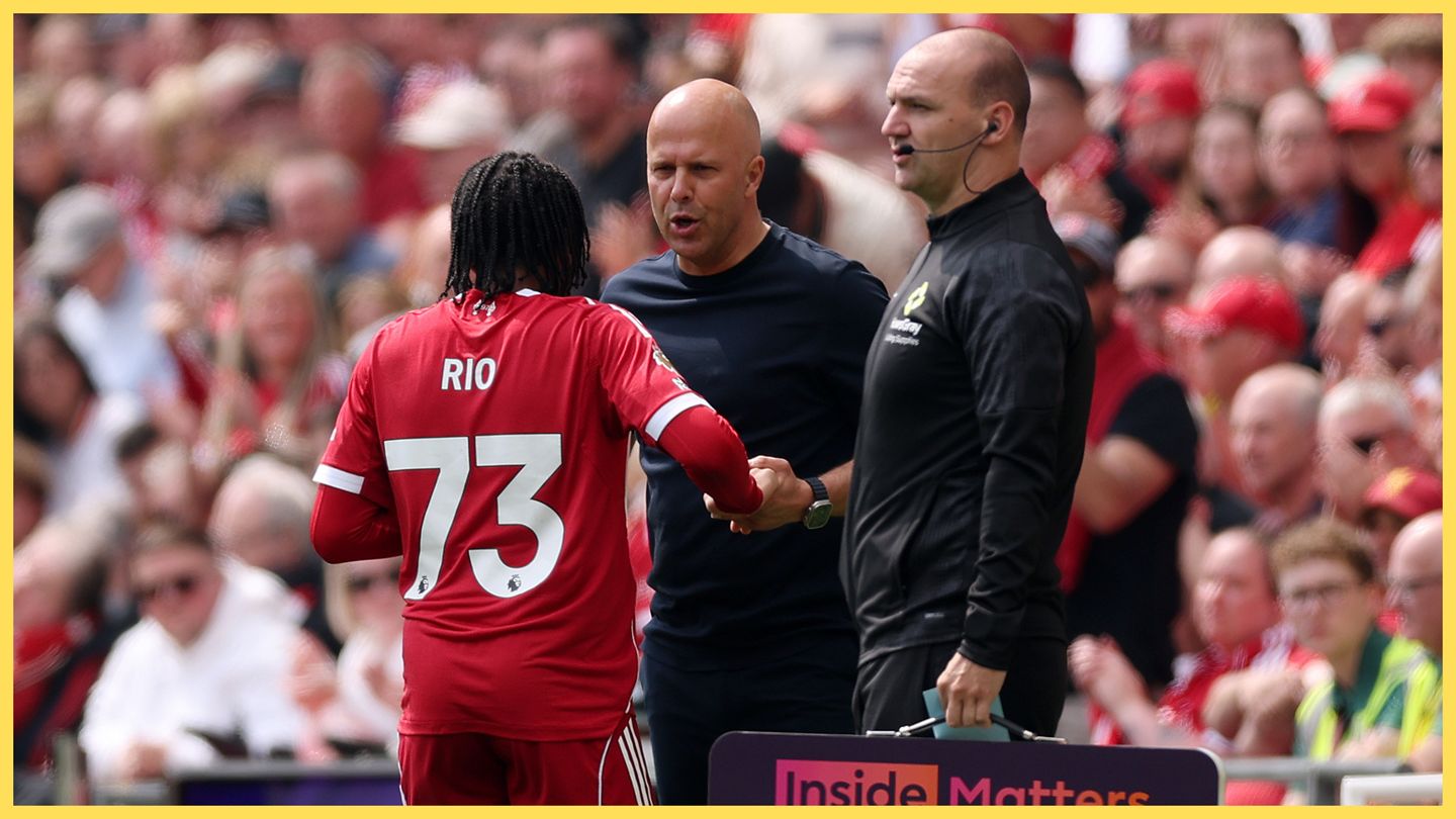 Rio Ngumoha speaks to Arne Slot on the touchline at Liverpool game.