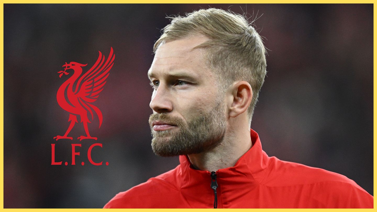 Konrad Laimer looks at Liverpool club crest.