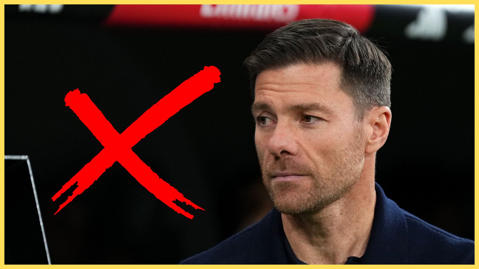 Xabi Alonso looks on next to a giant red X.