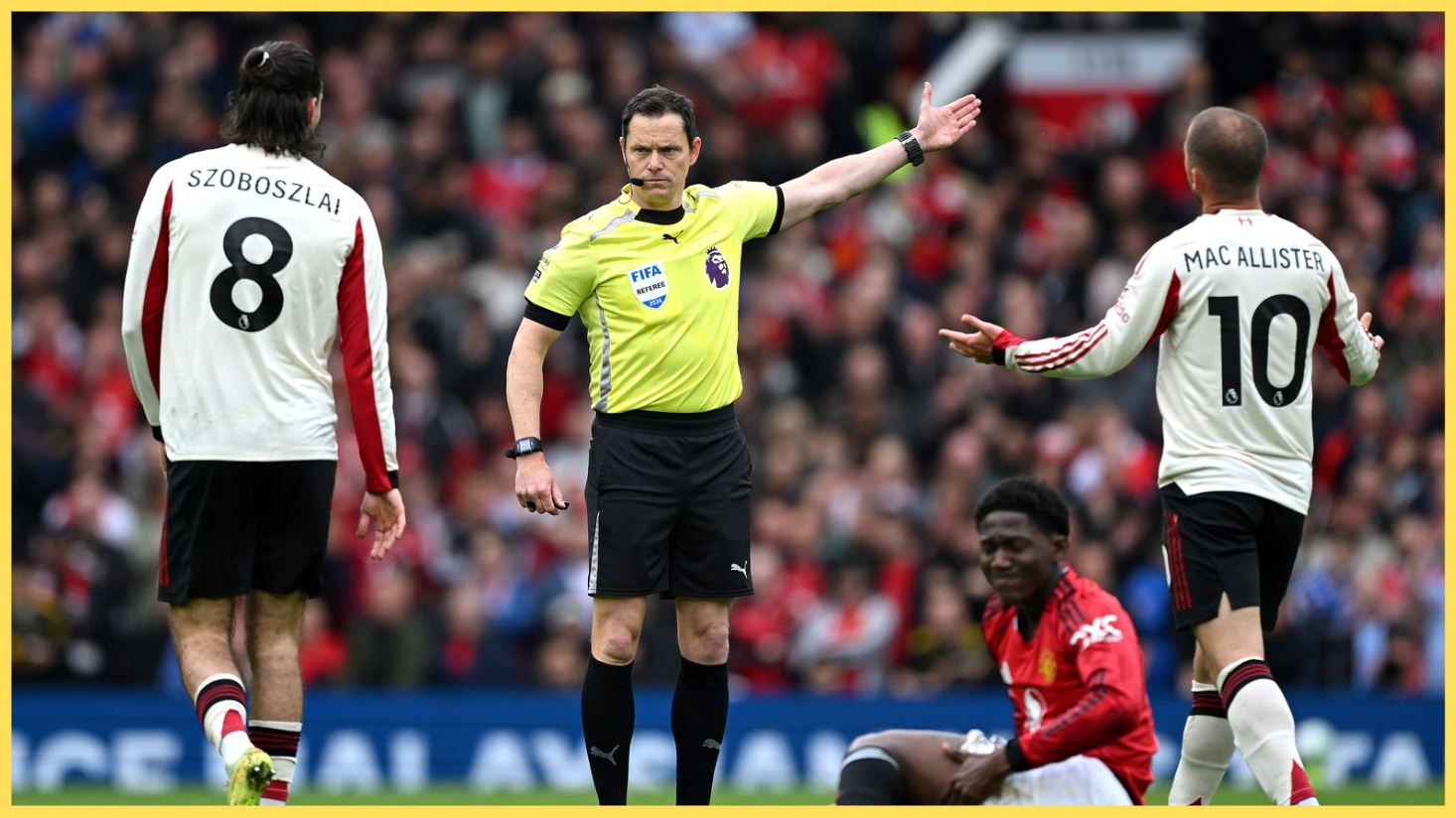 Liverpool players dispute a decision with referee Darren England