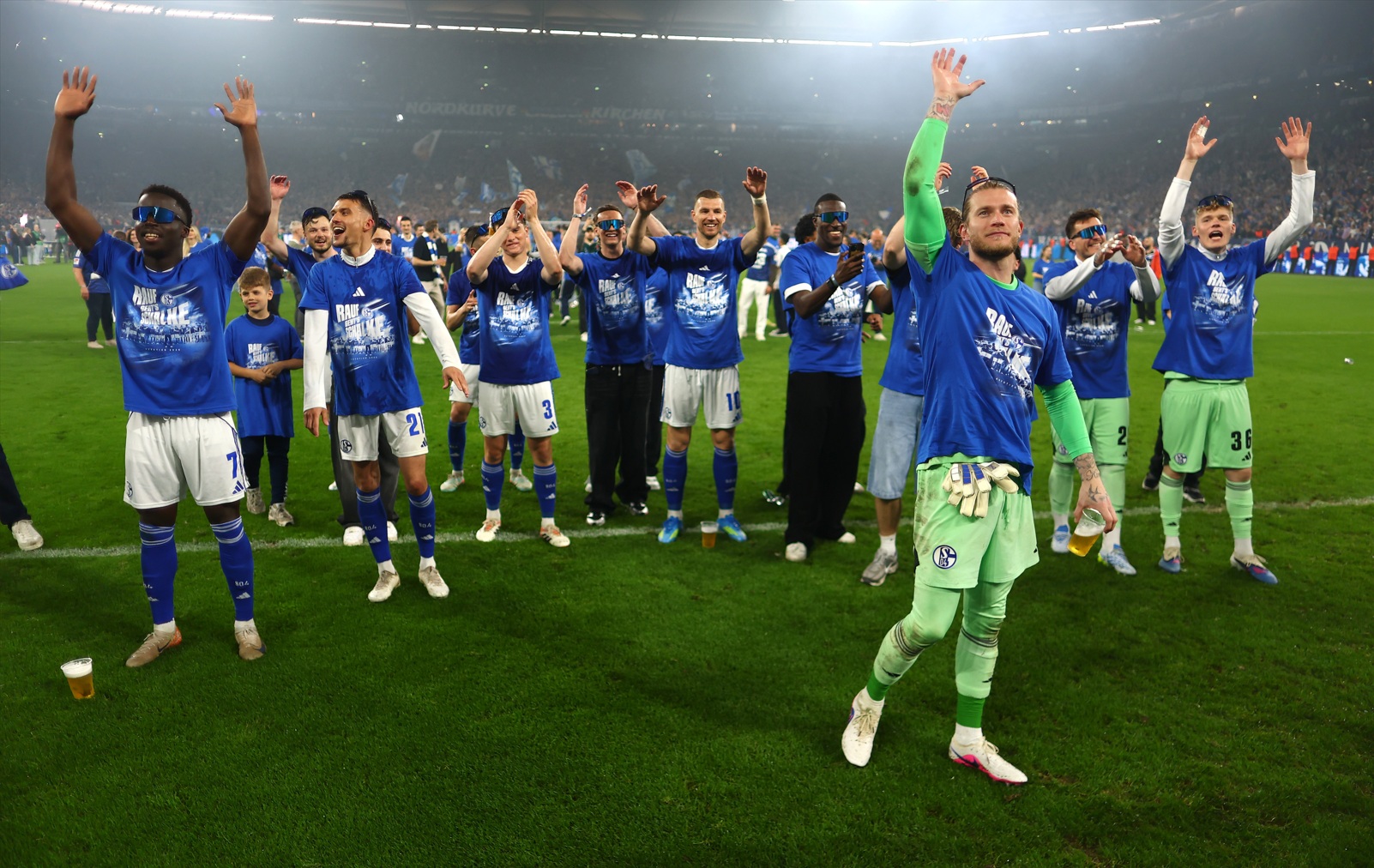 Ex-Liverpool goalkeeper Loris Karius celebrates with his Schalke 04 teammates after winning promotion to the Bundesliga