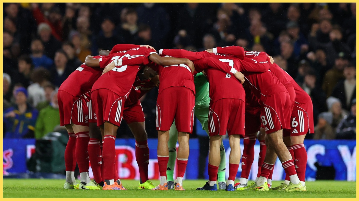 Liverpool players form a huddle prior to kick-off
