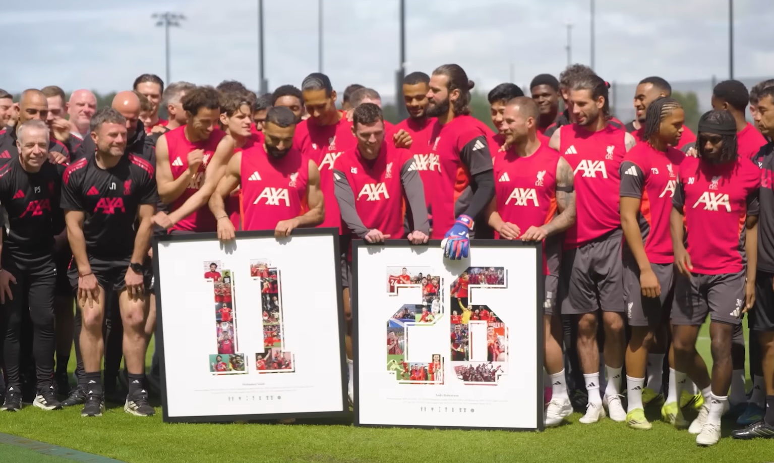 The Liverpool squad pose for a photo with Mo Salah and Andy Robertson during a presentation to the departing duo