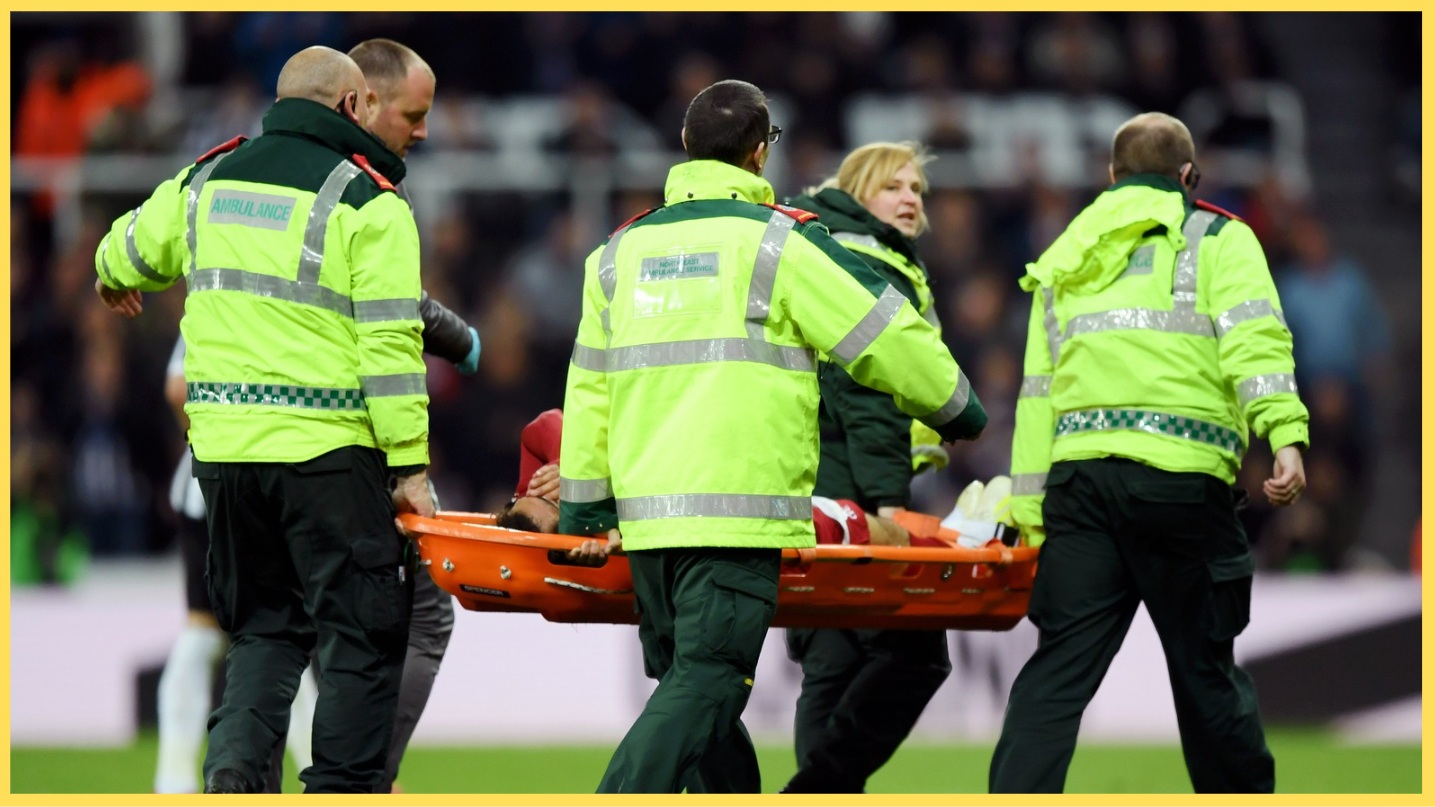 A Liverpool player leaves the field on a stretcher