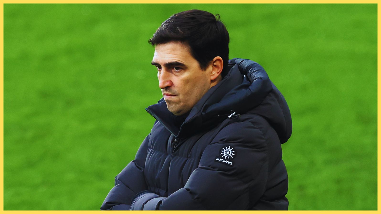 Liverpool manager Andoni Iraola looks frustrated as he crosses his arms.