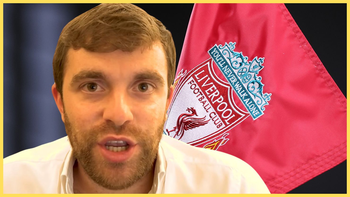 Fabrizio Romano speaks in front of a Liverpool flag.