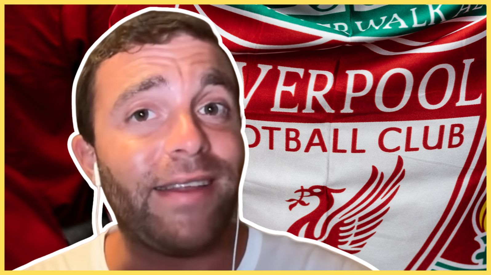 Fabrizio Romano smiles in front of Liverpool flag.