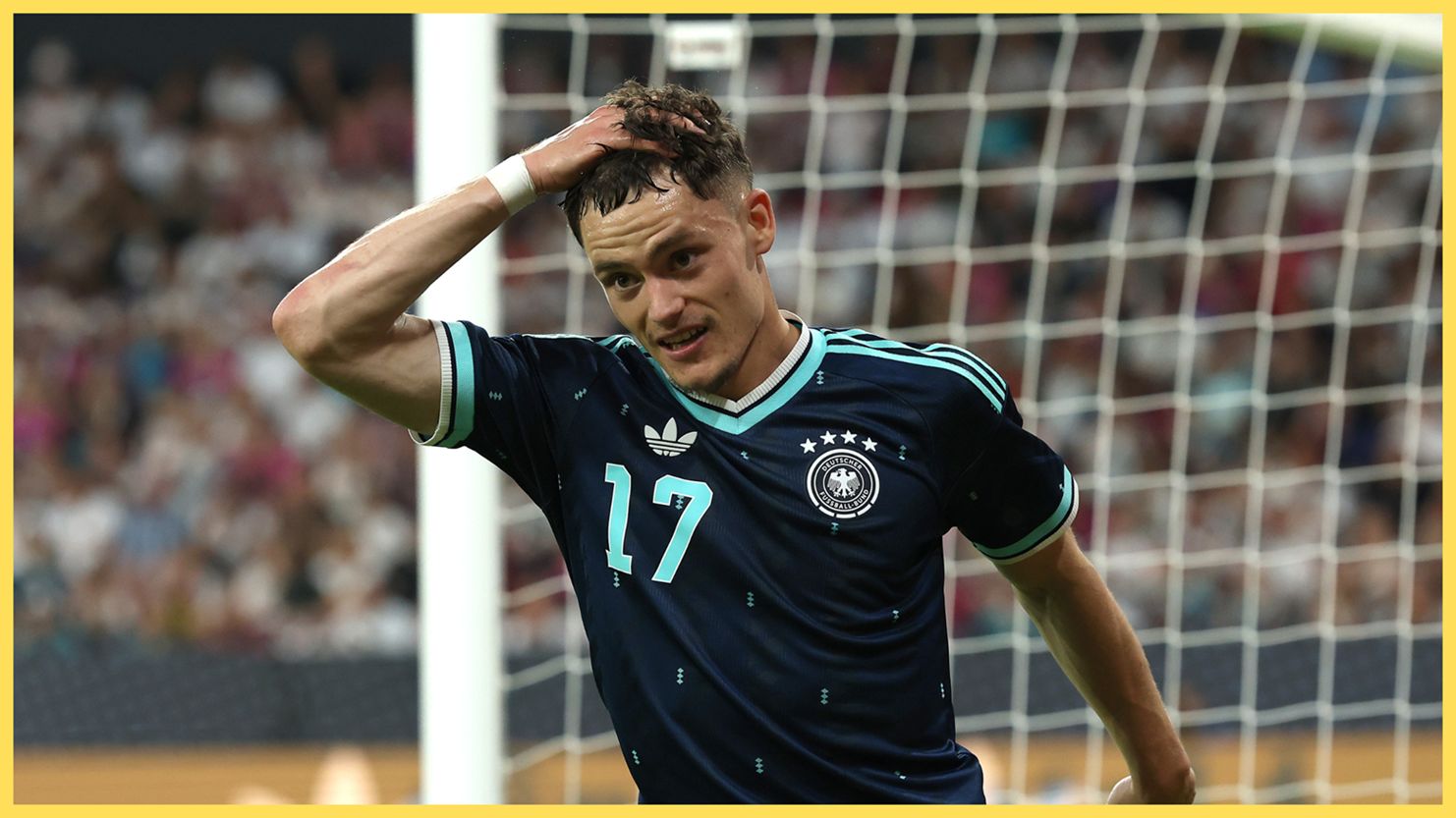 Liverpool midfielder Florian Wirtz grabs his head during Germany v Finland game.
