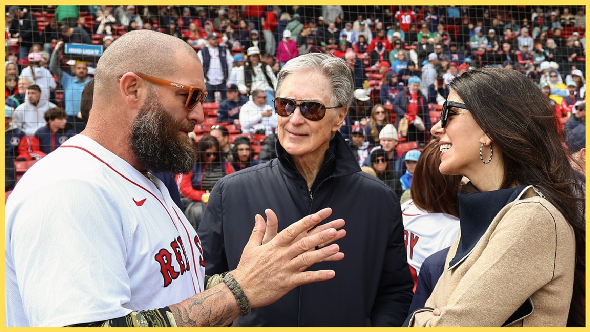 FSG president John Henry speaks with former baseball player Jonny Gomes
