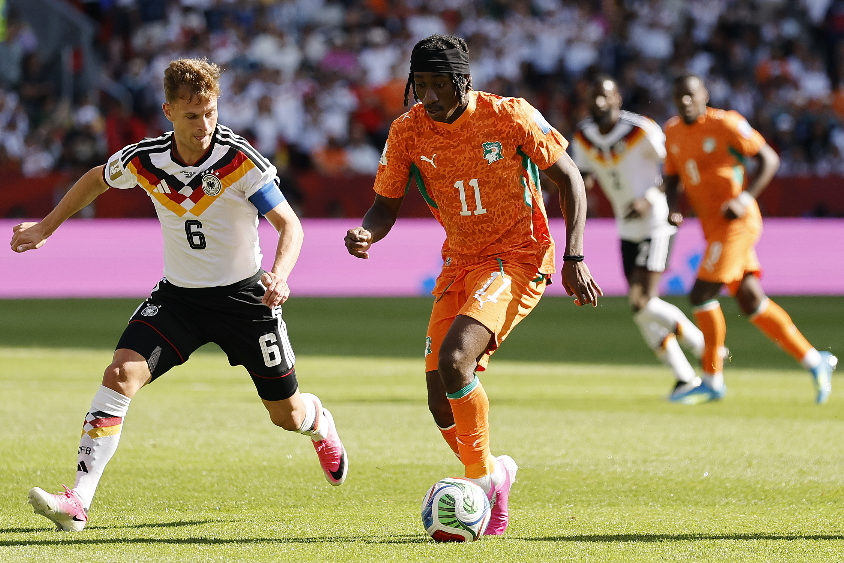 Yan Diomande is closely pursued by Joshua Kimmich