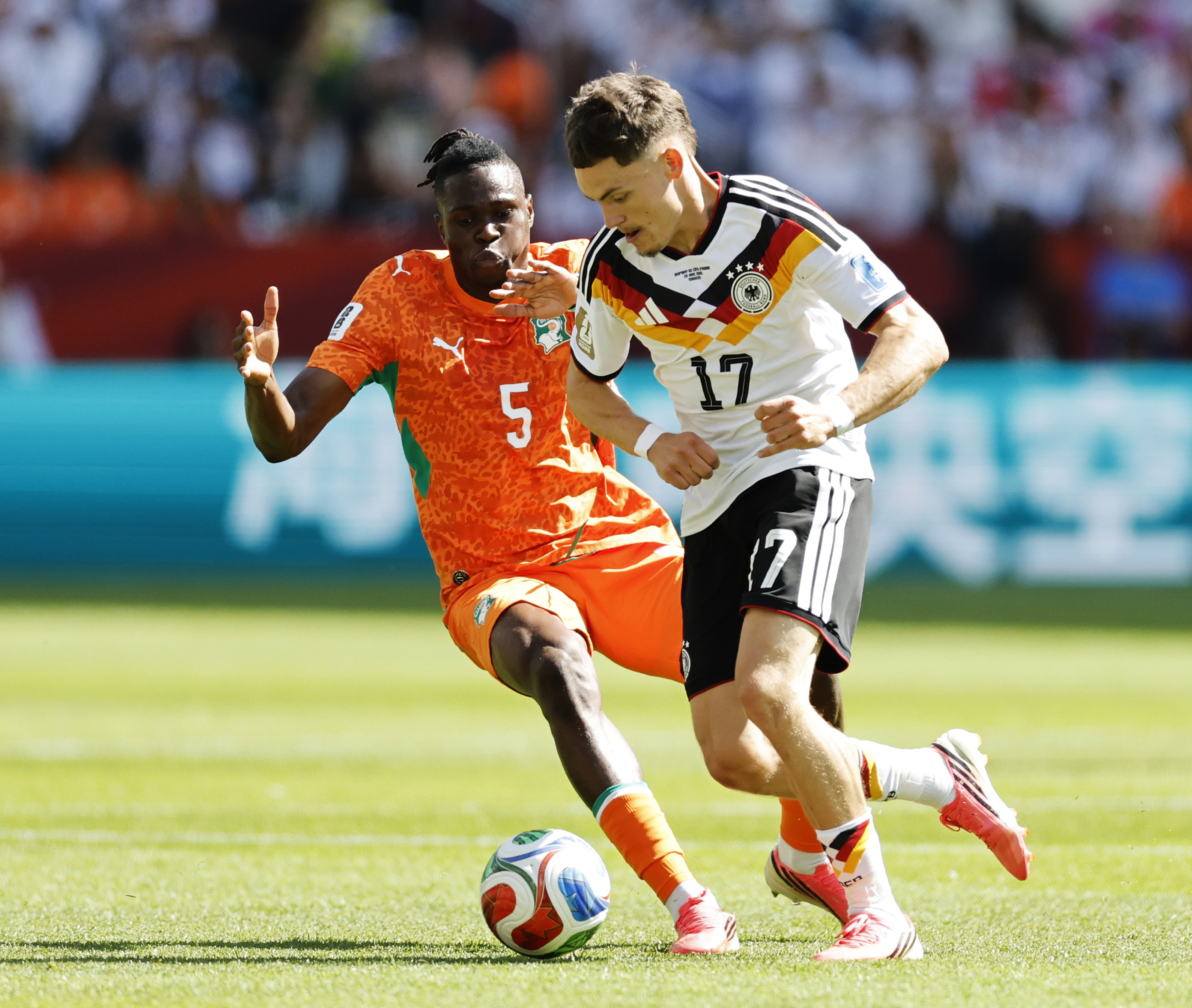 Florian Wirtz is challenged by Wilfried Singo