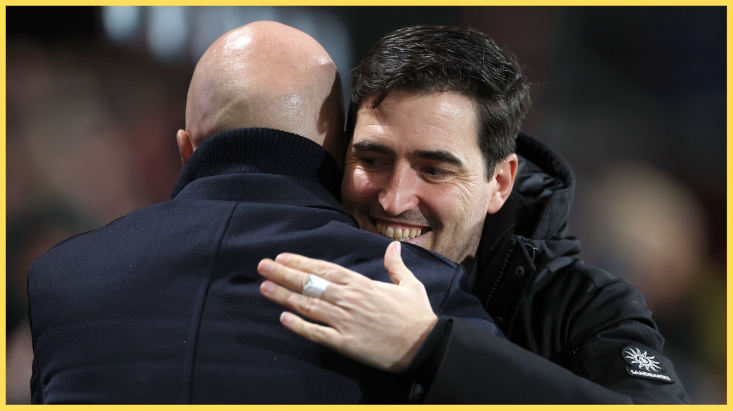 Andoni Iraola and Arne Slot embrace after a match between Bournemouth and Liverpool