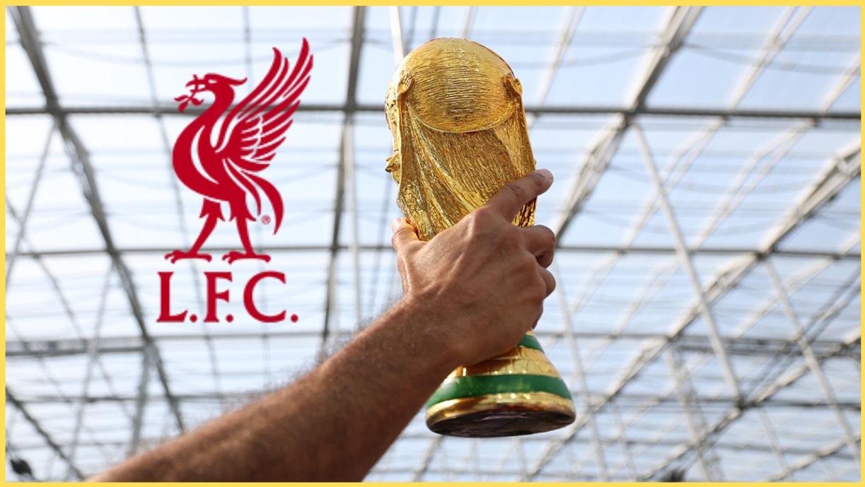 A supporter holds up a replica of the World Cup trophy