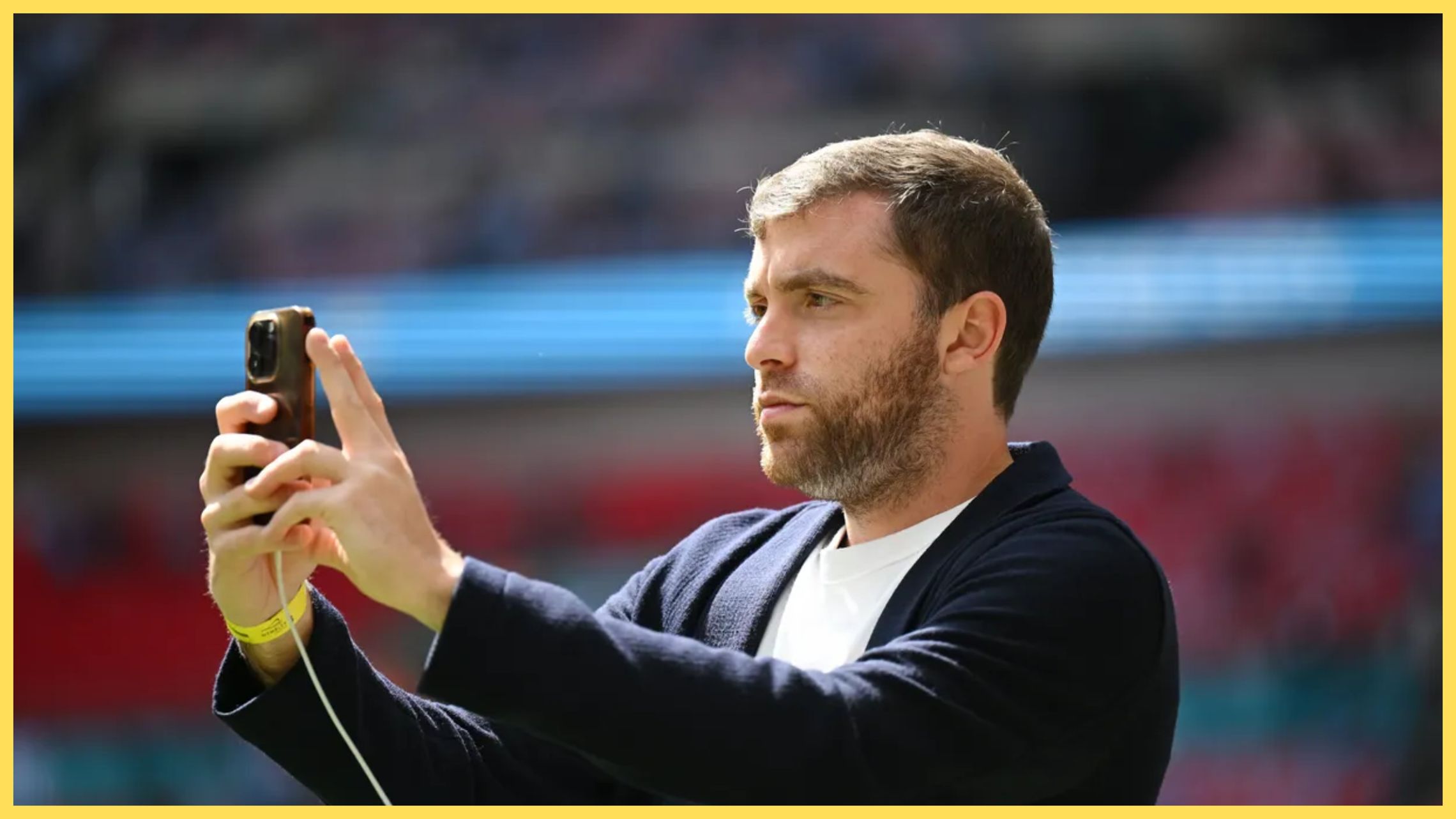 Transfer news expert Fabrizio Romano texts on his phone.