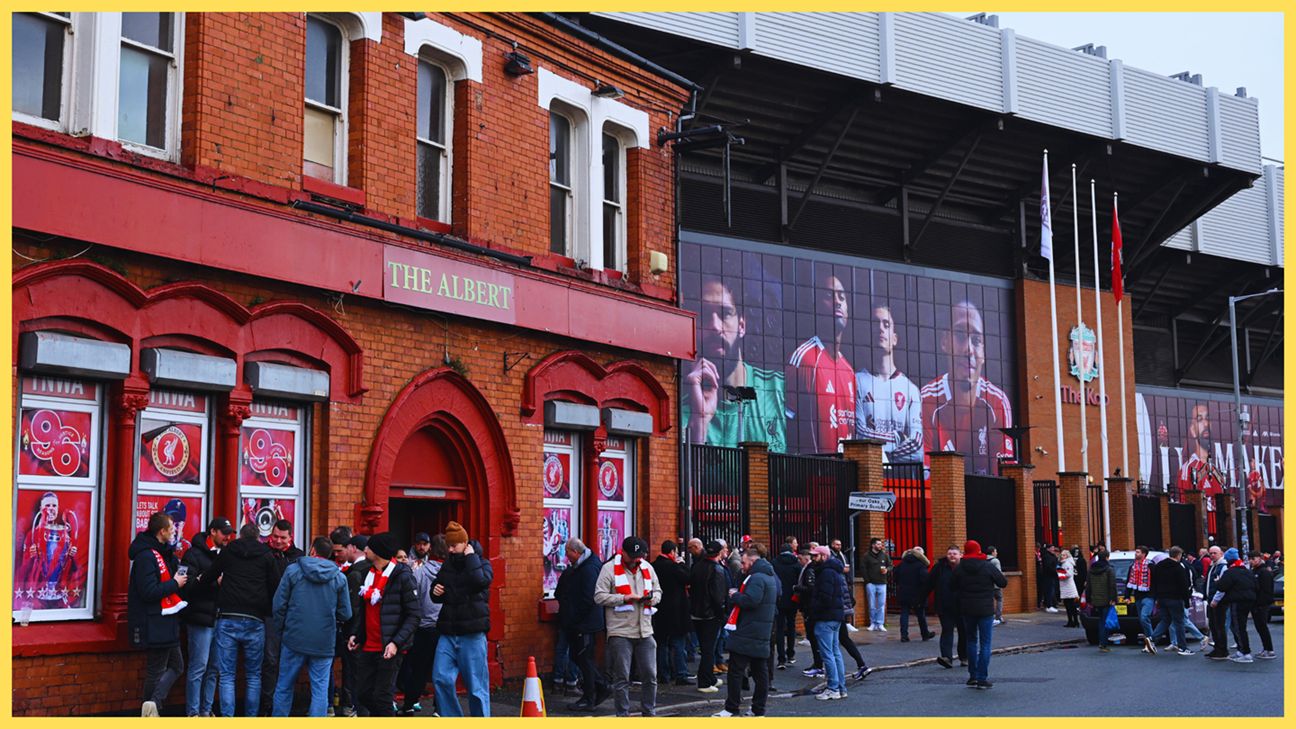 Liverpool fans queue outside of Anfield Stadium.