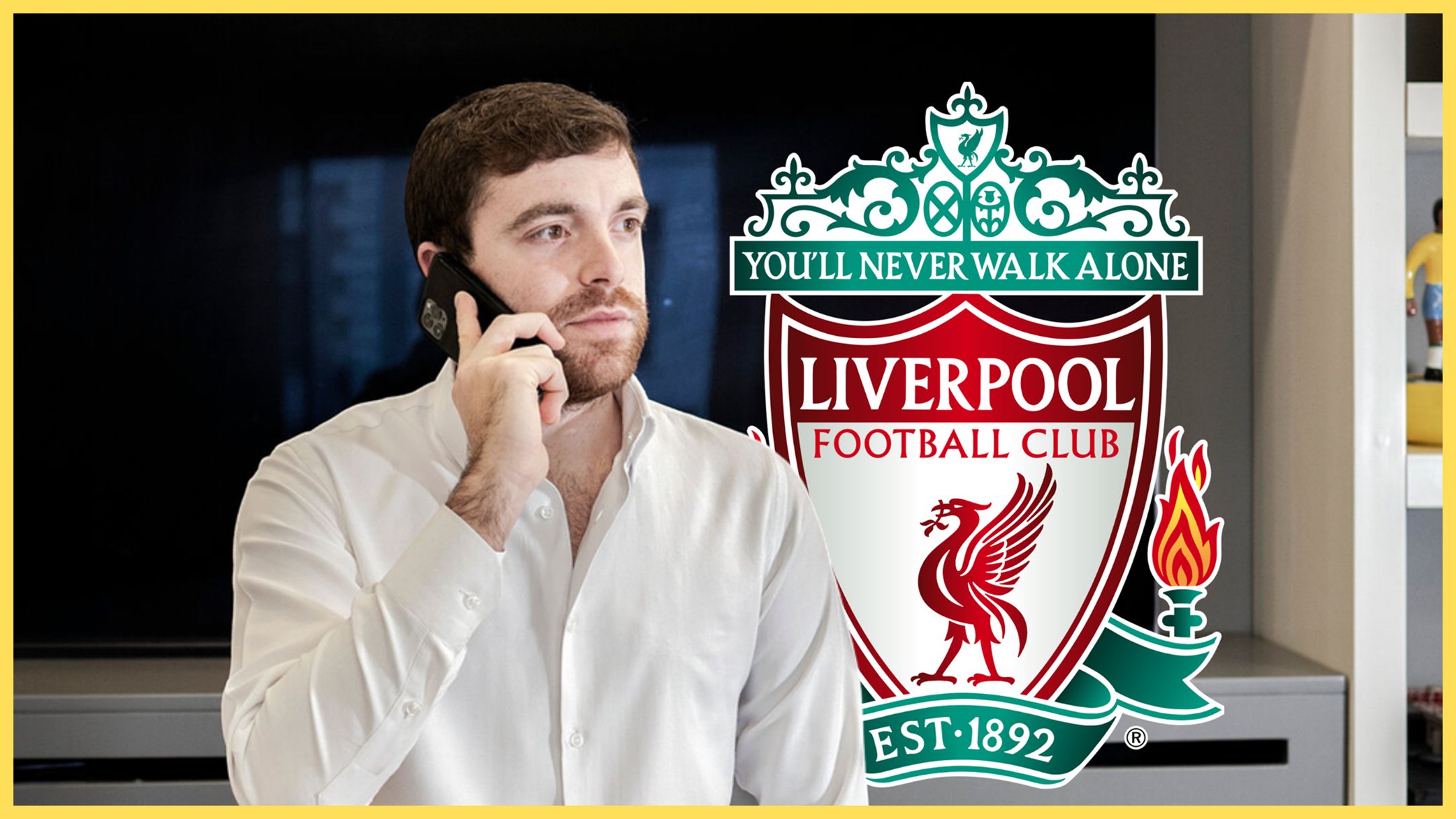 Transfer news expert Fabrizio Romano makes a phone call next to Liverpool club crest.