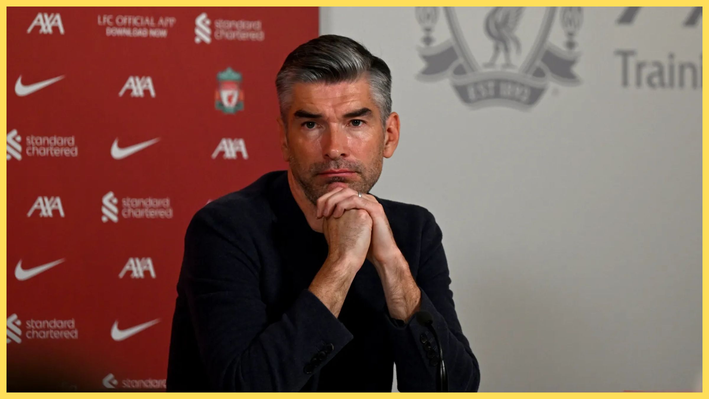 Liverpool sporting director Richard Hughes rests his chin on his folded hands.
